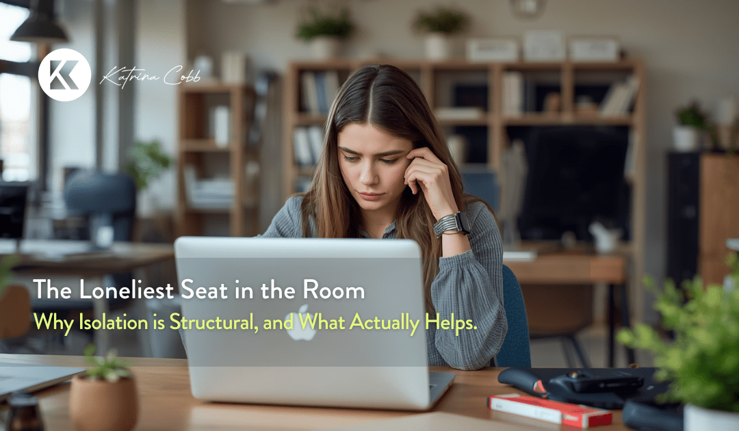 Woman business owner sitting alone at a desk, representing loneliness in business for women entrepreneurs